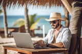 men and travel,Handsome relaxed man using laptop, beach background, 