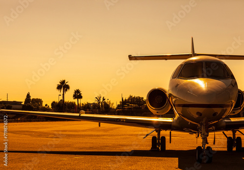 Beautiful private jet in golden setting sun