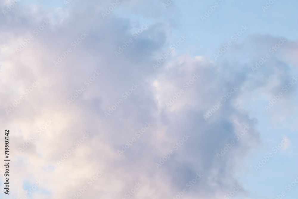 Blue sky background with pale pink clouds at sunset Blue sky background with pale pink clouds at sunset