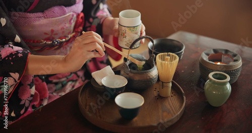 Traditional, matcha and Japanese woman with tea in home with herbs, powder and flavor in teapot. Ritual, indigenous culture and hand of person with herbal beverage for drinking, ceremony and wellness