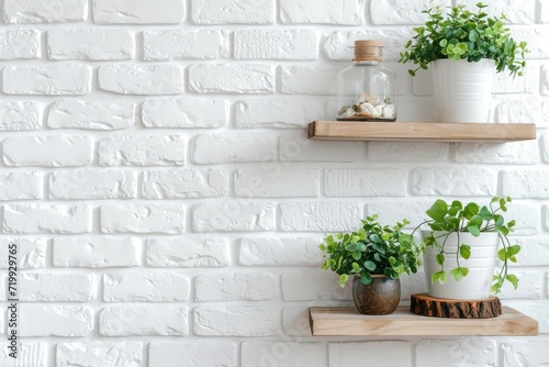 Modern white brick wall with shelves and houseplant. © kardaska