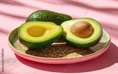 Avocado on a plate , solid color background photo