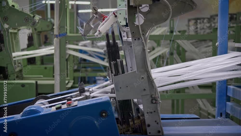 This stock video shows the operation of looms in a weaving factory. This video will decorate your projects related to the production of fabrics, weaving factories, industry. This stock video shows the operation of looms in a weaving factory. This video will decorate your projects related to the production of fabrics, weaving factories, industry.