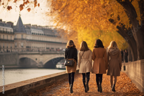 Strolling along the Seine River in autumn, the women in cozy fall fashion, surrounded by the warm hues of changing leaves.