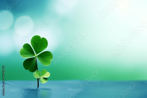 Clover leaf on a blue table on a blurred light green background. St. Patrick's Day celebration, luck and fortune concept, copy space
 photo