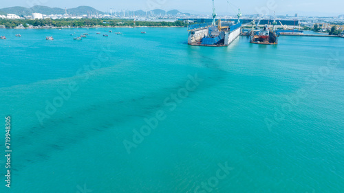Oil leak from Ship at dry dock , Oil spill pollution polluted water surface water pollution as a result of human activities. industrial chemical contamination. oil spill at sea. petroleum products.