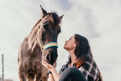 Young happy woman with her pony horse in evening sunset light. Outdoor photography with fashion model girl. Lifestyle mood. Concept of outdoor riding, sports and recreation.