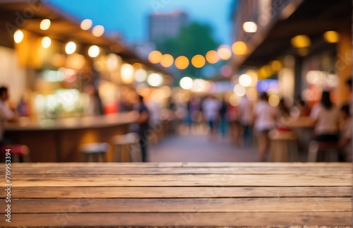 An empty wooden table on the background of street food courts, bokeh defocused background