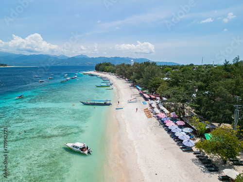 Drone photo of Indonesian island, Gili Trawangan and its beautiful crystal clear waters ideal for snorkeling and sailing typical boats. photo
