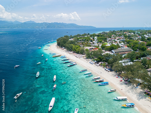 Drone photo of Indonesian island, Gili Trawangan and its beautiful crystal clear waters ideal for snorkeling and sailing typical boats. photo