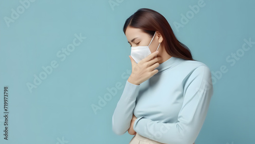 A woman suffering from a severe cold. Sore throat and laryngitis symptoms suggest a doctor's consultation. Prevent colds by wearing a mask. photo