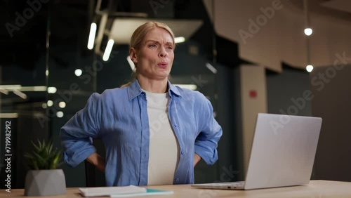 Wallpaper Mural Tired caucasian woman with blond hair suffering from pain in back after long work on wireless laptop. Female freelancer in blue shirt sitting at modern coworking space and having spinal discomfort. Torontodigital.ca