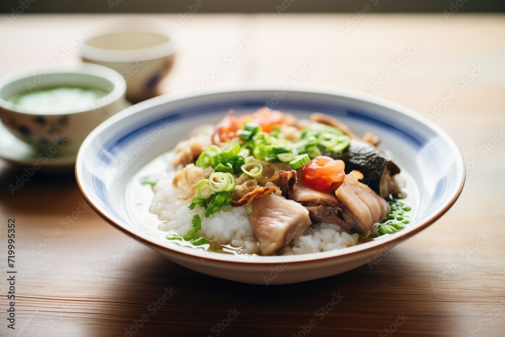 bowl of congee with century egg and pork