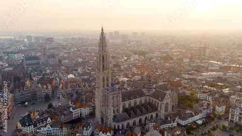 Antwerp, Belgium - July 21, 2023: Spire with the clock of the Cathedral of Our Lady (Antwerp). City Antwerp is located on river Scheldt (Escaut). Summer morning, Aerial View © nikitamaykov