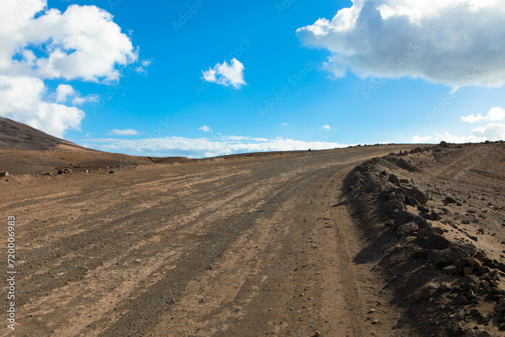 Dirt road in a volcanic landscape in Los Ajaches National Park near Papagayo beach. Playa Blanca, Lanzarote, Spain