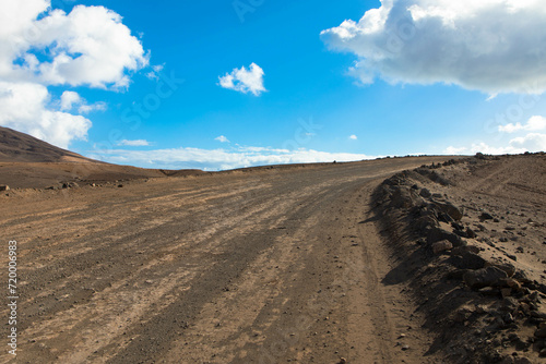 Dirt road in a volcanic landscape in Los Ajaches National Park near Papagayo beach. Playa Blanca, Lanzarote, Spain