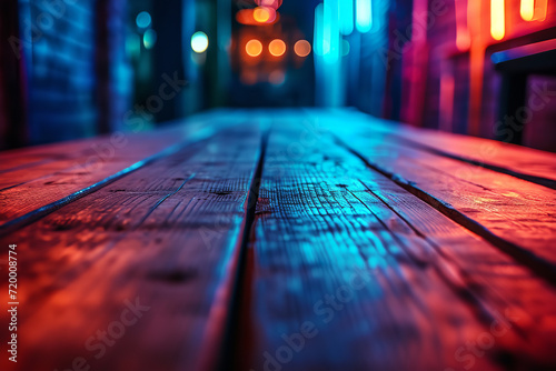 Wooden table, blurred bokeh background background. Neon light, night view, close-up