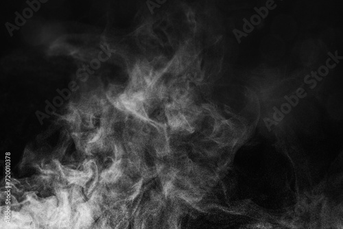 Blur white water vapour on isolated black background. Abstract of steam with copy space. Smoke on black background. Steam flow.