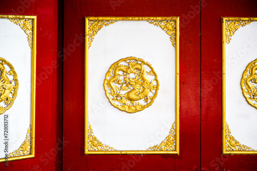 The wooden cabinets on the wall along with various Chinese-style decorations.