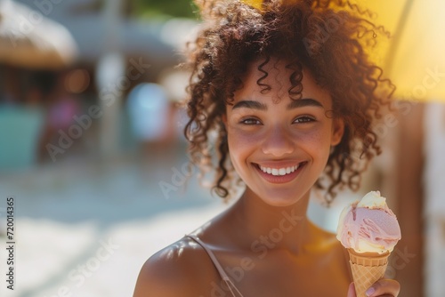 Portrait of a happy African American young woman with ice cream in a waffle cone on a sunny day  summer lifestyle