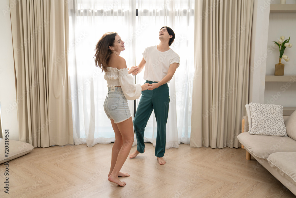 Beautiful young people dancing at home. Valentine's Day concept. Lovers at home celebrating Valentine's Day. Beautiful young people dancing at home. Valentine's Day concept. Lovers at home celebrating Valentine's Day.
