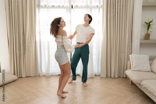 Beautiful young people dancing at home. Valentine's Day concept. Lovers at home celebrating Valentine's Day.