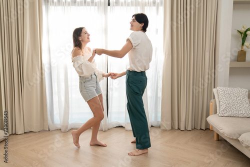 Beautiful young people dancing at home. Valentine's Day concept. Lovers at home celebrating Valentine's Day.