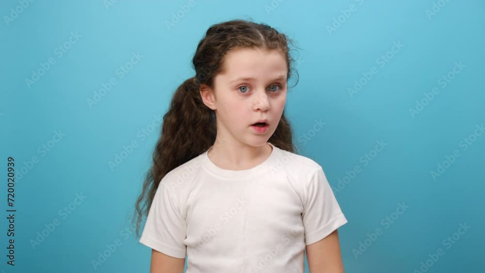 Portrait of preteen girl child looks at camera with shocked face