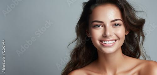 Beauty portrait of a happy young woman with glowing skin