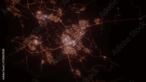 Karaganda (Kazakhstan) aerial view at night. Top view on modern city with street lights. Camera is zooming out, rotating clockwise. Vertical video. The north is on the left side photo