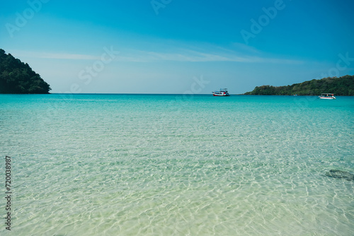 Tropical beach at Koh Kood, Thailand. turquoise sea water, ocean wave, yellow sand, green palms, sun blue sky, white clouds, beautiful seascape, summer holidays, exotic island vacation.