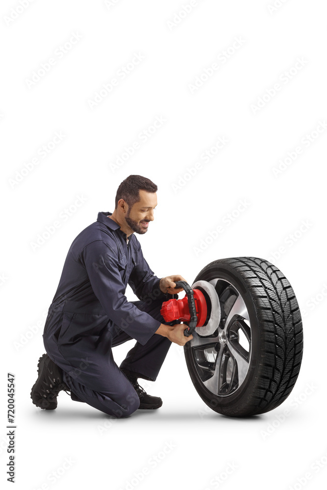 Mechanic using and auto polisher for a tire with a rim Mechanic using and auto polisher for a tire with a rim