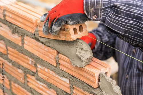 Hand worker masonry brickwork trowel construction site wall concrete background