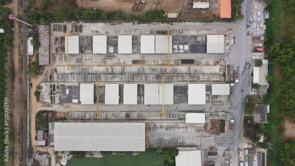 Aerial top view of Precast concrete wall panel for construction building site in warehouse factory. Precast concrete manufacturing products on prefabricated house factory. Aerial top view of Precast concrete wall panel for construction building site in warehouse factory. Precast concrete manufacturing products on prefabricated house factory.
