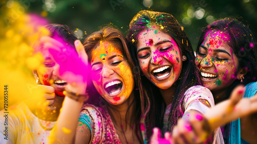 A group of friends in colorful attire celebrating Holi with bright gulal powder