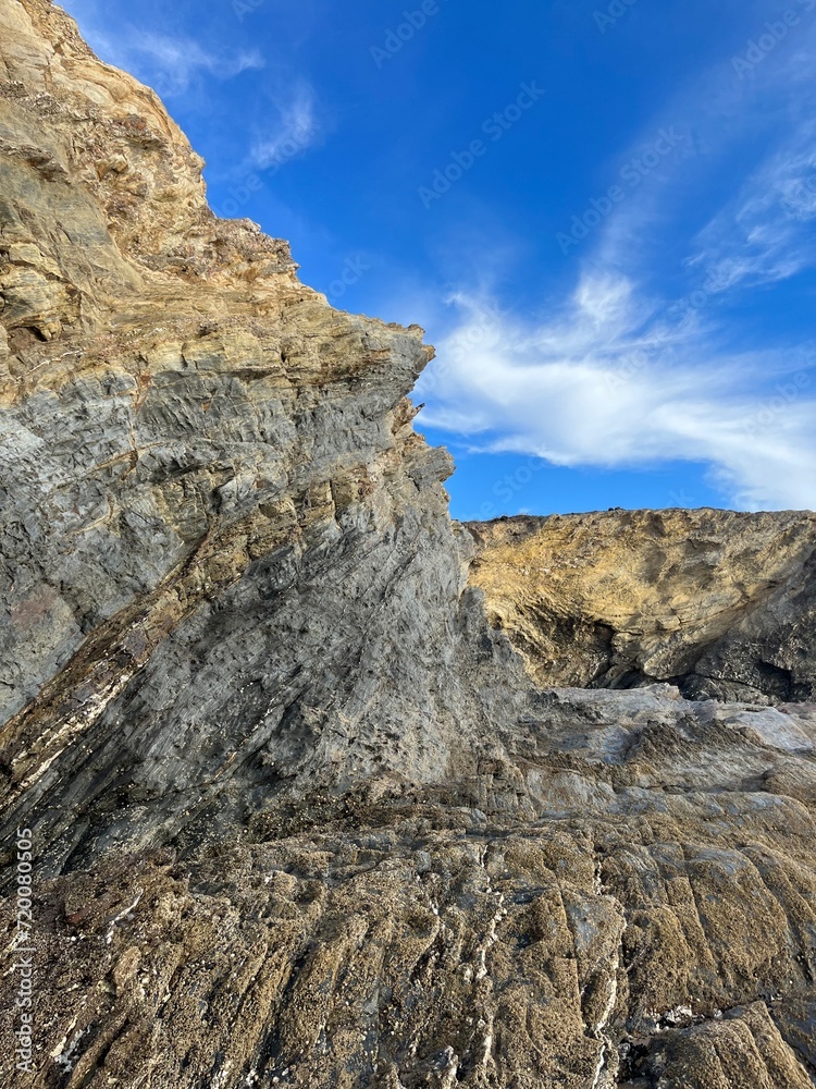 sandstone rock in the blue sky background, ocean rocky coast