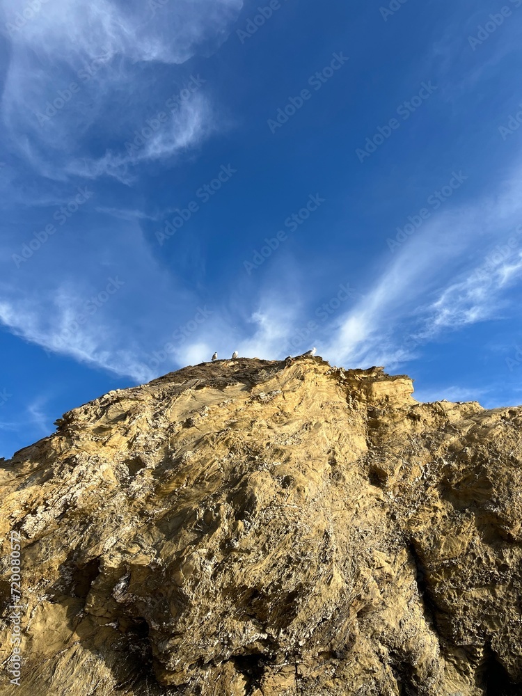 sandstone rock in the blue sky background, ocean rocky coast sandstone rock in the blue sky background, ocean rocky coast