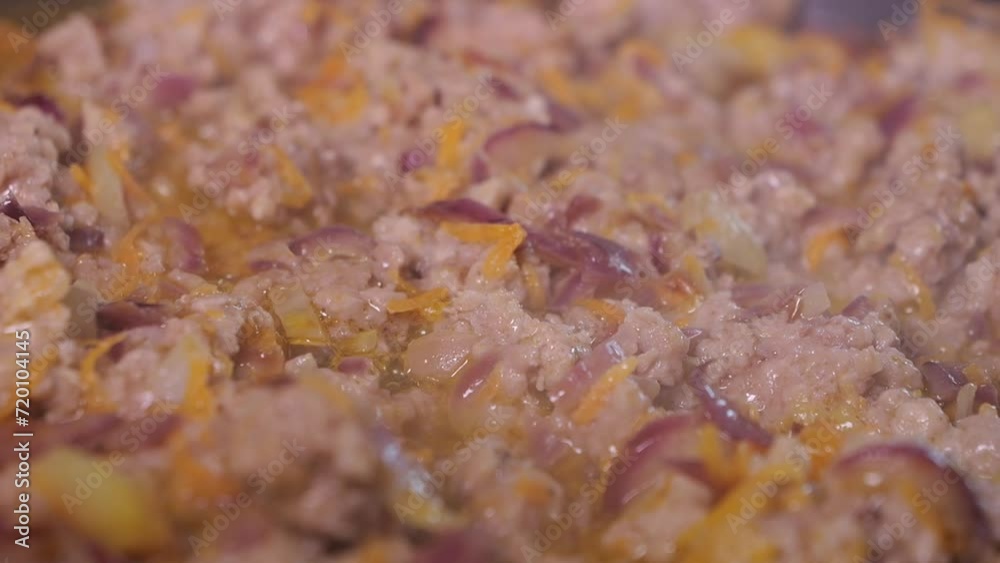 A dish of minced meat, tomato and vegetables is prepared in a pan. A dish of minced meat, tomato and vegetables is prepared in a pan.