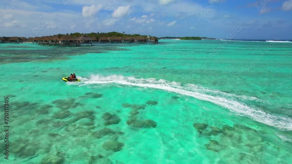 Maldives - Jetski - Kanifinolhu Island - wild action jetski aerial shot in the lagoon