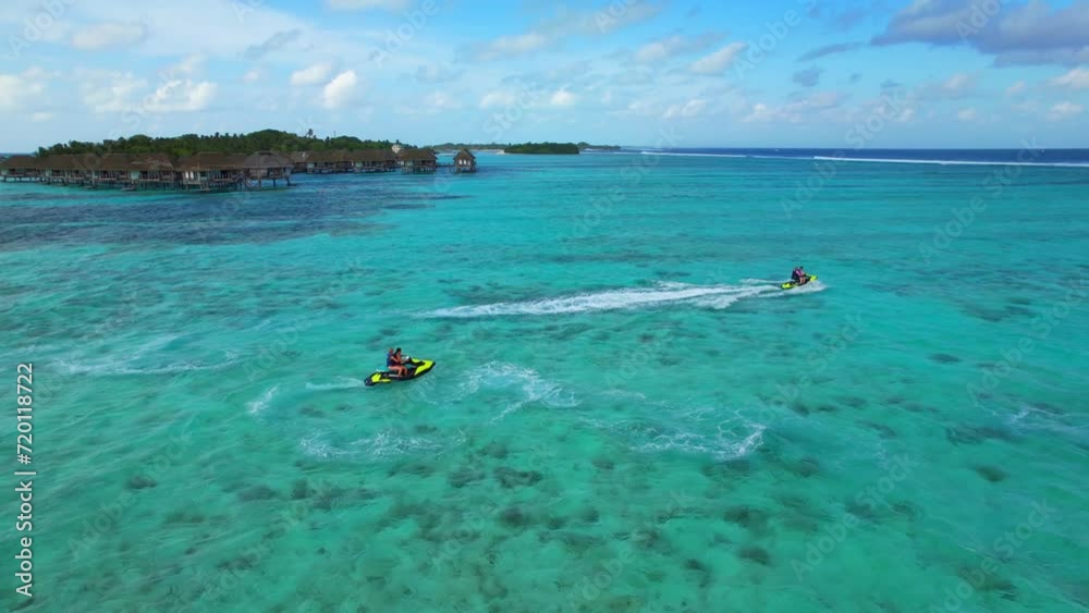 Maldives - Jetski - Kanifinolhu Island - Action Jetski aerial shot in front of the water bungalows Maldives - Jetski - Kanifinolhu Island - Action Jetski aerial shot in front of the water bungalows