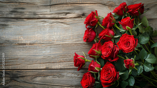 Bouquet of red roses on a textured wooden background