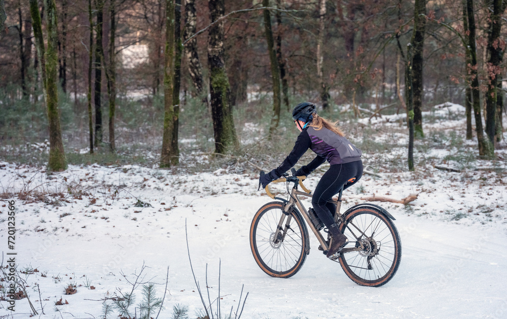 girl on moutain bike in snow covered forest girl on moutain bike in snow covered forest