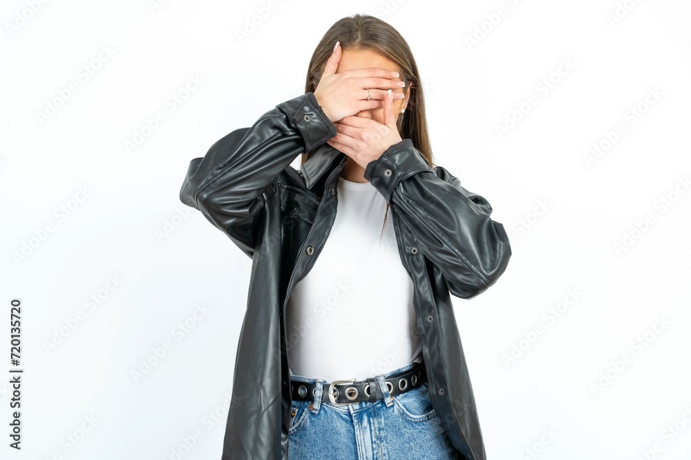 Young beautiful woman Covering eyes and mouth with hands, surprised and shocked. Hiding emotions. Young beautiful woman Covering eyes and mouth with hands, surprised and shocked. Hiding emotions.