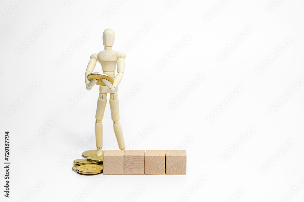 Wooden doll with wooden toy block isolated on white background. business or creative concept Wooden doll with wooden toy block isolated on white background. business or creative concept