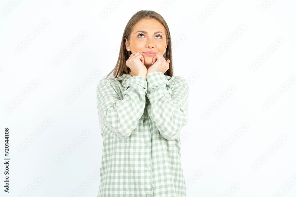 Portrait of sad Beautiful young woman wearing green plaid pyjama hands face look empty space Portrait of sad Beautiful young woman wearing green plaid pyjama hands face look empty space