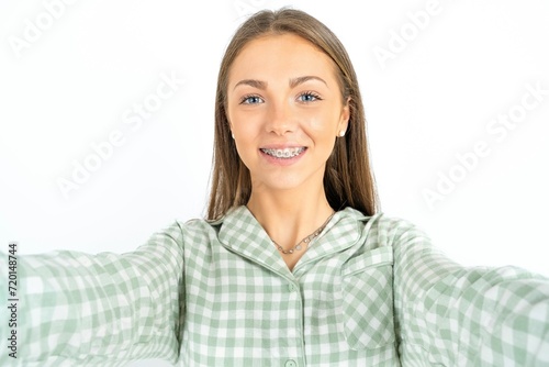 Photo of Beautiful young woman wearing green plaid pyjama do selfie