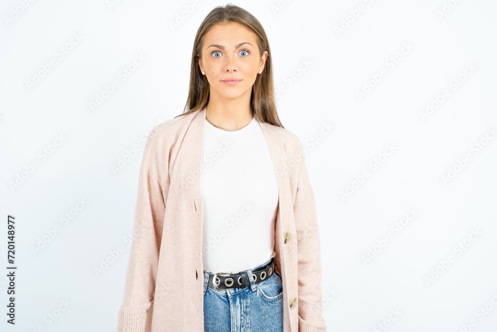 Stunned beautiful girl wearing casual clothes stares reacts on shocking news. Astonished teen girl holds breath Stunned beautiful girl wearing casual clothes stares reacts on shocking news. Astonished teen girl holds breath