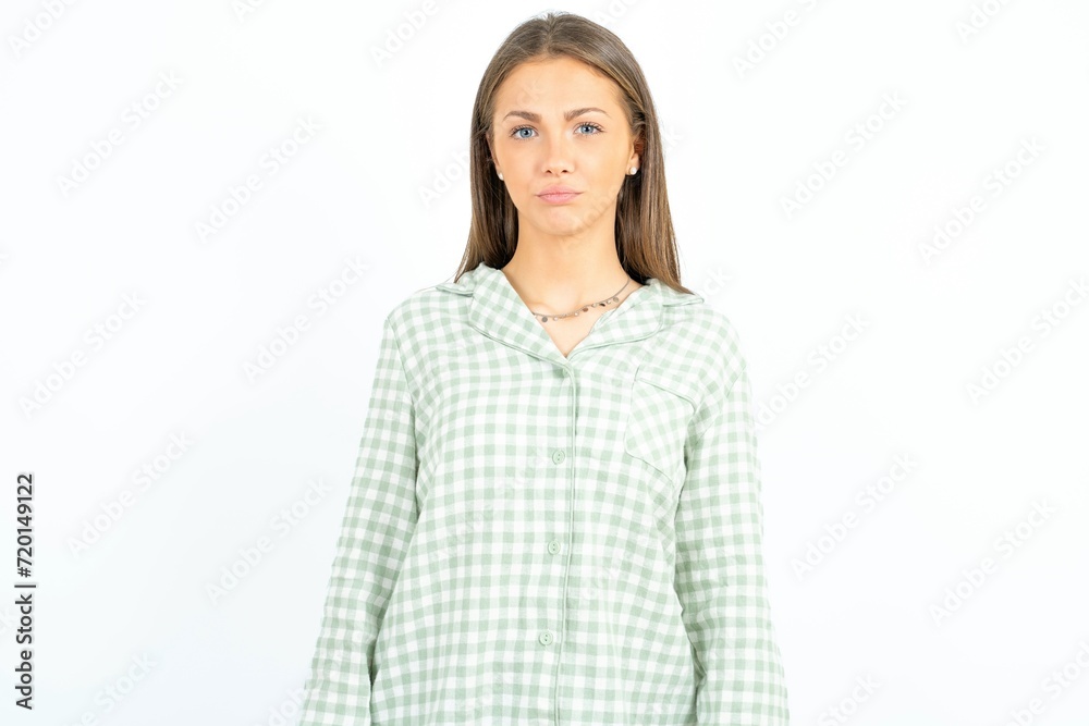 Beautiful young woman wearing green plaid pyjama depressed and worry for distress, crying angry and afraid. Sad expression. Beautiful young woman wearing green plaid pyjama depressed and worry for distress, crying angry and afraid. Sad expression.