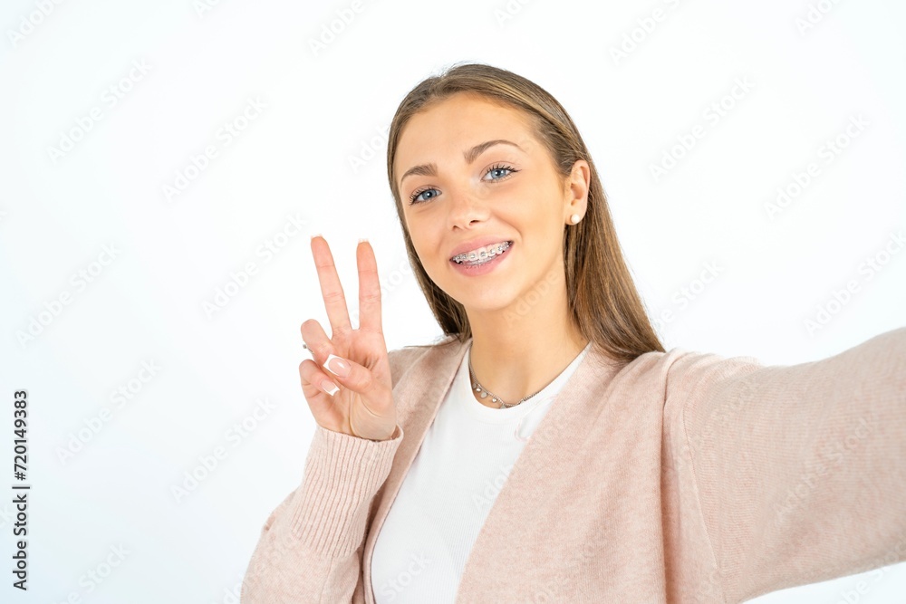 Positive beautiful girl wearing casual clothes take selfie make v-sign Positive beautiful girl wearing casual clothes take selfie make v-sign