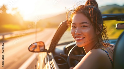 Young beautiful asian women getting new car. she very happy and excited. Smiling female driving vehicle on the road on a bright day. Copy space for text. photo